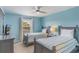 Bedroom with twin beds, neutral walls, ceiling fan, and a window at 8571 La Isla Dr, Kissimmee, FL 34747