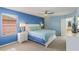 Bright bedroom featuring a large window, ensuite bathroom and king bed at 8571 La Isla Dr, Kissimmee, FL 34747