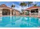 Beautiful community pool with inviting blue water, lounging areas, and a covered bar area, perfect for relaxing poolside at 8571 La Isla Dr, Kissimmee, FL 34747