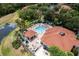 Community pool area with ample lounge chairs, cabanas, and a hot tub, providing a resort-style experience with manicured landscaping at 8571 La Isla Dr, Kissimmee, FL 34747