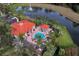 Aerial shot of community pool and clubhouse, surrounded by lush landscaping at 8571 La Isla Dr, Kissimmee, FL 34747