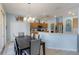 Open dining room with a modern chandelier, adjacent to a kitchen with stainless steel appliances at 8571 La Isla Dr, Kissimmee, FL 34747