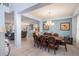 Elegant dining room featuring tile flooring, a large table set, and seamless flow to the living room at 8571 La Isla Dr, Kissimmee, FL 34747