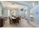 Bright dining room with tile flooring, chandelier, staircase, and an abundance of natural light at 8571 La Isla Dr, Kissimmee, FL 34747