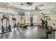 Well-equipped fitness center with cardio machines, free weights, and mirrored wall for a full body workout at 8571 La Isla Dr, Kissimmee, FL 34747