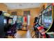Game room featuring various arcade-style games, hardwood floors, and window with privacy shades at 8571 La Isla Dr, Kissimmee, FL 34747