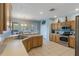 Bright kitchen with stainless appliances, granite counters and an exterior view from the double doors at 8571 La Isla Dr, Kissimmee, FL 34747