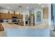 Charming kitchen featuring stainless steel appliances, breakfast bar and an arched display niche at 8571 La Isla Dr, Kissimmee, FL 34747