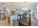 Spacious living room featuring an open floor plan and seamlessly connected to the dining and kitchen areas at 8571 La Isla Dr, Kissimmee, FL 34747