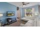 Bright living room with a white sectional sofa, large window, modern decor, and ample light at 8571 La Isla Dr, Kissimmee, FL 34747