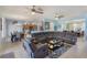Expansive living room with an open floor plan connecting the kitchen and dining area, featuring a sectional sofa at 8571 La Isla Dr, Kissimmee, FL 34747