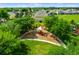 Neighborhood playground with colorful play structures, surrounded by lush greenery and mature trees, ideal for outdoor fun at 8571 La Isla Dr, Kissimmee, FL 34747
