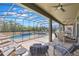Spacious screened-in pool area perfect for relaxing and entertaining with lounge chairs at 8571 La Isla Dr, Kissimmee, FL 34747