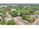An aerial view of a house in a neighborhood with many trees and other houses in the background on a sunny day at 918 Louise Ln, Deland, FL 32720