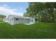 Exterior view of the backyard, featuring lush green grass and a patio at 918 Louise Ln, Deland, FL 32720