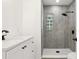 Bathroom featuring a walk-in shower with sleek black fixtures and a quartz countertop at 918 Louise Ln, Deland, FL 32720