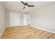 This bedroom has an overhead fan/light fixture, fresh paint, and durable, light-colored wood-look flooring at 918 Louise Ln, Deland, FL 32720