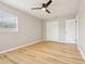 Bright bedroom featuring wood-look flooring, a ceiling fan, and closet at 918 Louise Ln, Deland, FL 32720