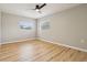 Neutral bedroom featuring wood-look flooring, a ceiling fan, and bright windows at 918 Louise Ln, Deland, FL 32720