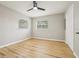 Spacious bedroom with wood-look flooring, a ceiling fan, and bright windows at 918 Louise Ln, Deland, FL 32720