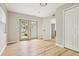 This sun-filled flex room provides access to the rear yard, fresh paint, and stylish, light-colored wood-look flooring at 918 Louise Ln, Deland, FL 32720