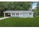 Charming one-story home featuring a well-manicured lawn and covered parking at 918 Louise Ln, Deland, FL 32720
