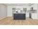 Bright kitchen featuring stainless steel appliances, a stylish backsplash, and a kitchen island at 918 Louise Ln, Deland, FL 32720