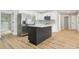 Bright kitchen with stainless steel appliances, white cabinetry, and a kitchen island at 918 Louise Ln, Deland, FL 32720