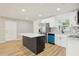Bright kitchen with stainless steel appliances, white cabinets, and a kitchen island at 918 Louise Ln, Deland, FL 32720