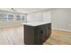 Spacious room showcasing the kitchen island, hardwood floors and neutral wall paint at 918 Louise Ln, Deland, FL 32720