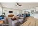 This living room features hardwood floors, modern furniture, and is open to the kitchen at 918 Louise Ln, Deland, FL 32720