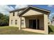A covered patio provides an outdoor living space, shown with an open door to the interior at 979 Hacienda Cir, Kissimmee, FL 34741