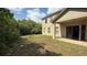 Side view of the house with a lawn perfect for outdoor relaxation and activities at 979 Hacienda Cir, Kissimmee, FL 34741