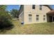 Side view of the house with a lawn perfect for outdoor relaxation and activities at 979 Hacienda Cir, Kissimmee, FL 34741
