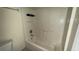 A bathroom featuring a white tiled bathtub with shower and grab bars at 979 Hacienda Cir, Kissimmee, FL 34741