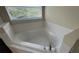 Bathroom showing a white soaking tub with tile surround and chrome fixtures at 979 Hacienda Cir, Kissimmee, FL 34741