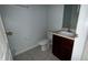 Powder room with tile flooring, toilet, and single dark wood vanity with a stone countertop at 979 Hacienda Cir, Kissimmee, FL 34741