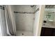 Modern bathroom shower featuring tile walls, handheld shower head, and dark wood vanity at 979 Hacienda Cir, Kissimmee, FL 34741
