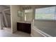 Bathroom with a walk-in shower, soaking tub, dark wood vanity and granite countertop at 979 Hacienda Cir, Kissimmee, FL 34741