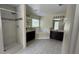 Bright bathroom featuring a walk-in shower, soaking tub, and dual dark wood vanities at 979 Hacienda Cir, Kissimmee, FL 34741