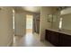 Large bathroom featuring a walk-in shower and dark wood vanity with granite countertop at 979 Hacienda Cir, Kissimmee, FL 34741