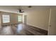 Spacious bedroom features wood-look flooring, a ceiling fan, and natural light from two large windows at 979 Hacienda Cir, Kissimmee, FL 34741