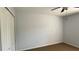 Bedroom with soft natural light and a closet provides concealed storage space and plush carpeting at 979 Hacienda Cir, Kissimmee, FL 34741