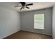 A simple bedroom showcases a window with light filtering through the blinds at 979 Hacienda Cir, Kissimmee, FL 34741