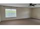 Bedroom featuring a ceiling fan and a large window at 979 Hacienda Cir, Kissimmee, FL 34741