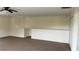Spacious bonus room with neutral paint, a half wall, tan carpet and recessed lighting at 979 Hacienda Cir, Kissimmee, FL 34741