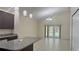 Open dining area with granite topped island, tile flooring and French doors leading to the yard at 979 Hacienda Cir, Kissimmee, FL 34741