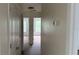 Hallway with tan carpet, neutral paint and white doors leading to other rooms at 979 Hacienda Cir, Kissimmee, FL 34741