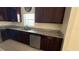 A well-equipped kitchen featuring dark wood cabinetry and granite countertops at 979 Hacienda Cir, Kissimmee, FL 34741
