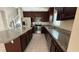 Spacious kitchen with stainless appliances, granite counters, island and dark wood cabinets at 979 Hacienda Cir, Kissimmee, FL 34741